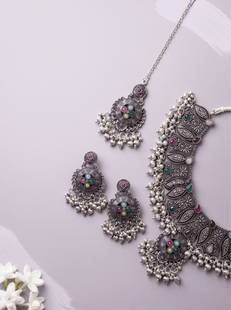 Oxidised silver necklace and earrings set on lilac fabric